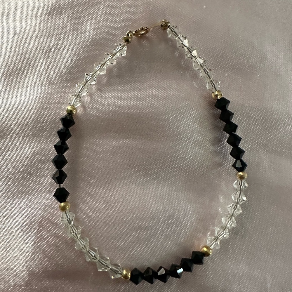 Swarovski clear and black onyx with gold plated balls and clasp. Great accessory